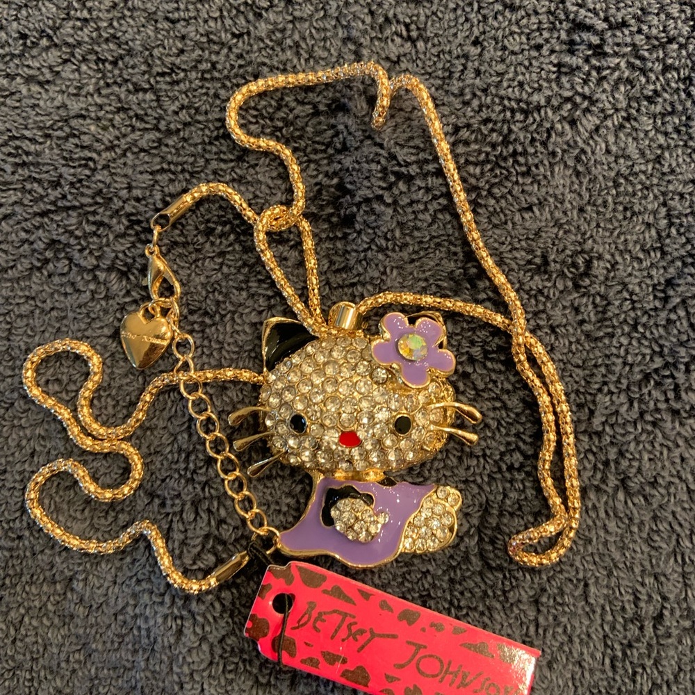 On sale! BJ Johnston Hello Kitty with purple, clear rhinestones. Drop is 12”.